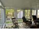 Sunroom filled with light has white trim windows and tile floor at 2528 Beech Gap Ct, Raleigh, NC 27603
