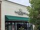 Exterior view of Salty Turtle Beer Co. with a green awning and turtle logo on the building at 2565 Bent Green St, Raleigh, NC 27614