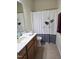 Comfortable bathroom featuring a vanity, toilet, and shower with a decorative floral curtain at 2565 Bent Green St, Raleigh, NC 27614