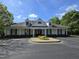 Inviting clubhouse featuring classic architectural elements, lush landscaping, and convenient parking spaces at 2565 Bent Green St, Raleigh, NC 27614