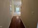Hallway with hardwood floors and view into the living room at 2565 Bent Green St, Raleigh, NC 27614