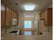 Kitchen with wood cabinets and view into the dining and living rooms at 2565 Bent Green St, Raleigh, NC 27614