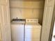 Convenient laundry area features a washer, dryer, and overhead shelving for storage solutions at 2565 Bent Green St, Raleigh, NC 27614