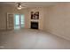 Living room with carpet, ceiling fan, fireplace, and view into a sunroom at 2565 Bent Green St, Raleigh, NC 27614