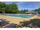 A community pool with lounge chairs and umbrellas offers residents a resort-like experience on a sunny day at 2565 Bent Green St, Raleigh, NC 27614