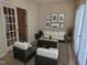 Bright sun room featuring modern seating, a stylish rug, and ample natural light at 2565 Bent Green St, Raleigh, NC 27614
