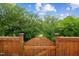 Backyard gate provides access to a lush, green wooded area, perfect for nature lovers at 270 Oak Park Blvd, Youngsville, NC 27596