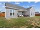 Backyard featuring gray siding, well-maintained lawn, and a patio perfect for outdoor seating and grilling at 270 Oak Park Blvd, Youngsville, NC 27596