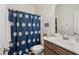 Neat bathroom featuring vanity sink and a blue and white patterned shower curtain at 270 Oak Park Blvd, Youngsville, NC 27596