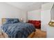 Bedroom featuring a full-sized bed and a red sofa at 270 Oak Park Blvd, Youngsville, NC 27596