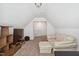 Finished attic space featuring neutral carpeting and a white sofa at 270 Oak Park Blvd, Youngsville, NC 27596