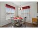Bright dining area with a round table, four chairs, and natural light from the windows creating a cozy space at 270 Oak Park Blvd, Youngsville, NC 27596