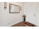Bright entryway features wood-look floors, a decorative mirror, and a charming vase of flowers adding a touch of elegance at 270 Oak Park Blvd, Youngsville, NC 27596