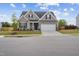 Charming two-story home with a manicured lawn, attached garage, and welcoming entrance, perfect for a growing Gathering at 270 Oak Park Blvd, Youngsville, NC 27596