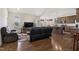 Open-concept living room and kitchen with stainless steel appliances and hardwood floors at 270 Oak Park Blvd, Youngsville, NC 27596
