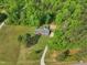 Aerial view of home featuring a private fenced yard, in-ground pool, and wooded setting at 2705 Flat Rock Rd, Franklinton, NC 27525