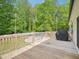 Outdoor deck with wooden railing and a grill, offering a view of the backyard and an above-ground swimming pool at 2705 Flat Rock Rd, Franklinton, NC 27525