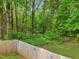 The lush backyard features a privacy fence and mature trees at 2705 Flat Rock Rd, Franklinton, NC 27525