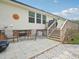 Inviting backyard patio with outdoor seating, string lights, and a view of the home's exterior and landscaped surroundings at 2705 Flat Rock Rd, Franklinton, NC 27525