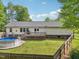 Backyard view of home featuring an above-ground pool, deck, patio, and fenced yard at 2705 Flat Rock Rd, Franklinton, NC 27525