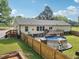 Exterior backyard view of home featuring an above-ground pool, deck, and fenced yard at 2705 Flat Rock Rd, Franklinton, NC 27525