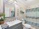 Bathroom features a single vanity, backsplash, and neutral paint and a shower with curtain at 2705 Flat Rock Rd, Franklinton, NC 27525