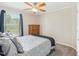 Comfortable bedroom features a ceiling fan, neutral walls, closet and large window to let in natural light at 2705 Flat Rock Rd, Franklinton, NC 27525