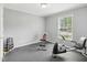 A simple exercise room with rubber flooring, weight rack, work out bench and exercise bike at 2705 Flat Rock Rd, Franklinton, NC 27525