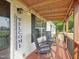 Cozy front porch featuring rocking chairs, wooden floors, and charming string lights for relaxing outdoors at 2705 Flat Rock Rd, Franklinton, NC 27525