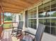 Comfortable front porch with chairs, perfect for relaxing and enjoying the view with string lights at 2705 Flat Rock Rd, Franklinton, NC 27525