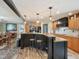 Spacious kitchen features wood cabinets, stone countertops, stainless appliances, and breakfast bar seating at 2705 Flat Rock Rd, Franklinton, NC 27525