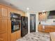 The kitchen shows off black appliances, lots of wooden cabinets and a door to the pantry at 2705 Flat Rock Rd, Franklinton, NC 27525