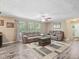 Cozy living room featuring neutral sofas, a ceiling fan, modern flooring, and large windows at 2705 Flat Rock Rd, Franklinton, NC 27525