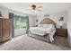 Spacious main bedroom with carpet, a large window letting in natural light, and an inviting bed at 2705 Flat Rock Rd, Franklinton, NC 27525
