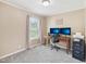 Cozy office space features neutral paint, plush carpet, and a window offering natural light, with a wooden desk and dual monitors at 2705 Flat Rock Rd, Franklinton, NC 27525