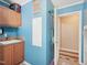 Functional utility sink area with wooden cabinets and countertop space, located near the entrance to an adjoining room at 2705 Flat Rock Rd, Franklinton, NC 27525