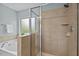 Bright bathroom featuring a tiled shower and soaking tub with frosted glass window, offering natural light and privacy at 2728 Evanston Ave, Durham, NC 27703