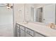 Bright bathroom featuring a white vanity with a large mirror, modern fixtures, and a view into the bedroom at 2728 Evanston Ave, Durham, NC 27703