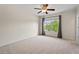 Bright bedroom with a ceiling fan, neutral carpet, and large window offering natural light at 2728 Evanston Ave, Durham, NC 27703