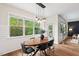 Dining room features a stylish light fixture and a large window overlooking a lush backyard at 2728 Evanston Ave, Durham, NC 27703