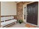 Cozy front porch featuring stone accents, a white bench, and decorative plants at 2728 Evanston Ave, Durham, NC 27703