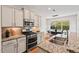 Bright eat-in kitchen features stainless steel appliances, granite countertops, and opens to the dining area at 2728 Evanston Ave, Durham, NC 27703