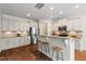 Bright kitchen features white cabinets, granite countertops, stainless steel appliances, and breakfast bar seating at 2728 Evanston Ave, Durham, NC 27703