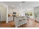 Well-lit kitchen with granite countertops, white cabinetry, and a breakfast bar overlooking the dining area at 2728 Evanston Ave, Durham, NC 27703