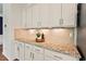 Granite countertops with backsplash and under cabinet lights illuminate this kitchen space at 2728 Evanston Ave, Durham, NC 27703