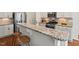 Kitchen bar with granite countertops and decorative white corbels offers casual seating and adds elegance at 2728 Evanston Ave, Durham, NC 27703