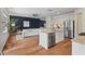 Open concept living area with hardwood floors, a navy accent wall, and stainless steel appliances at 2728 Evanston Ave, Durham, NC 27703