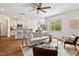 Inviting living room with hardwood floors, a modern ceiling fan, and ample natural light at 2728 Evanston Ave, Durham, NC 27703
