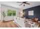 Comfortable living space featuring hardwood floors and stylish, navy accent wall at 2728 Evanston Ave, Durham, NC 27703