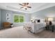 Spacious main bedroom with tray ceiling, ceiling fan, and ample natural light at 2728 Evanston Ave, Durham, NC 27703
